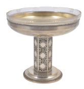 A Secessionist style silver plated comport, early 20th century, with glass liner supported on a