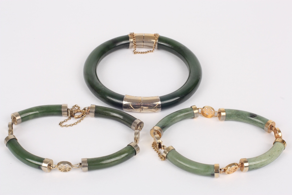 Two jade bracelets, Modern together with a nephrite bangle, diameter of bangle 8cm . All appear to