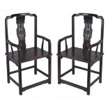 A pair of Chinese hardwood chairs, with curved carved back splats and shaped arms, 112cm high,