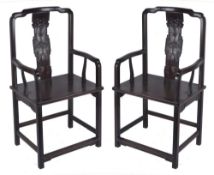 A pair of Chinese hardwood chairs, with curved carved back splats and shaped arms, 112cm high,