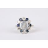 An Art Deco Sapphire and diamond cluster ring
set with central pale blue sapphire surrounded by