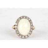 An 18ct gold, diamond and opal ring
the large oval opal surrounded by small diamonds and set in an
