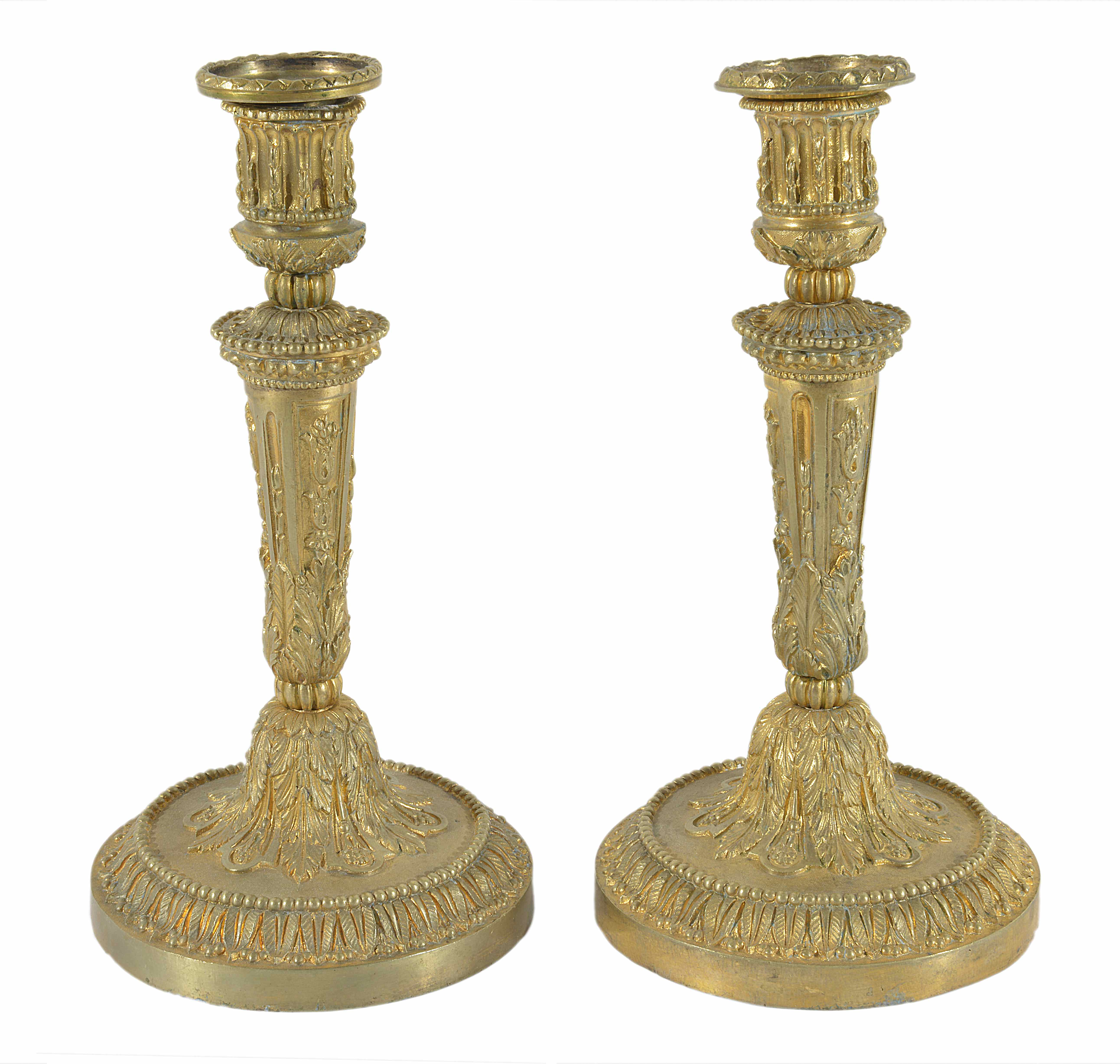 A pair of ornate gilt metal candlesticks
probably late 19th century
with tapering stems and cast
