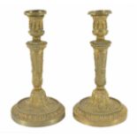 A pair of ornate gilt metal candlesticks
probably late 19th century
with tapering stems and cast