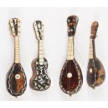 Three 19th century miniature tortoiseshell mandolins and a guitar
with ivory, bone and and another