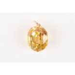 A large yellow sapphire in a pendant mount
the sapphire of oval form and set in a six claw mount,