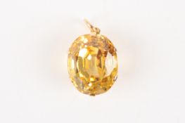 A large yellow sapphire in a pendant mountthe sapphire of oval form and set in a six claw mount,