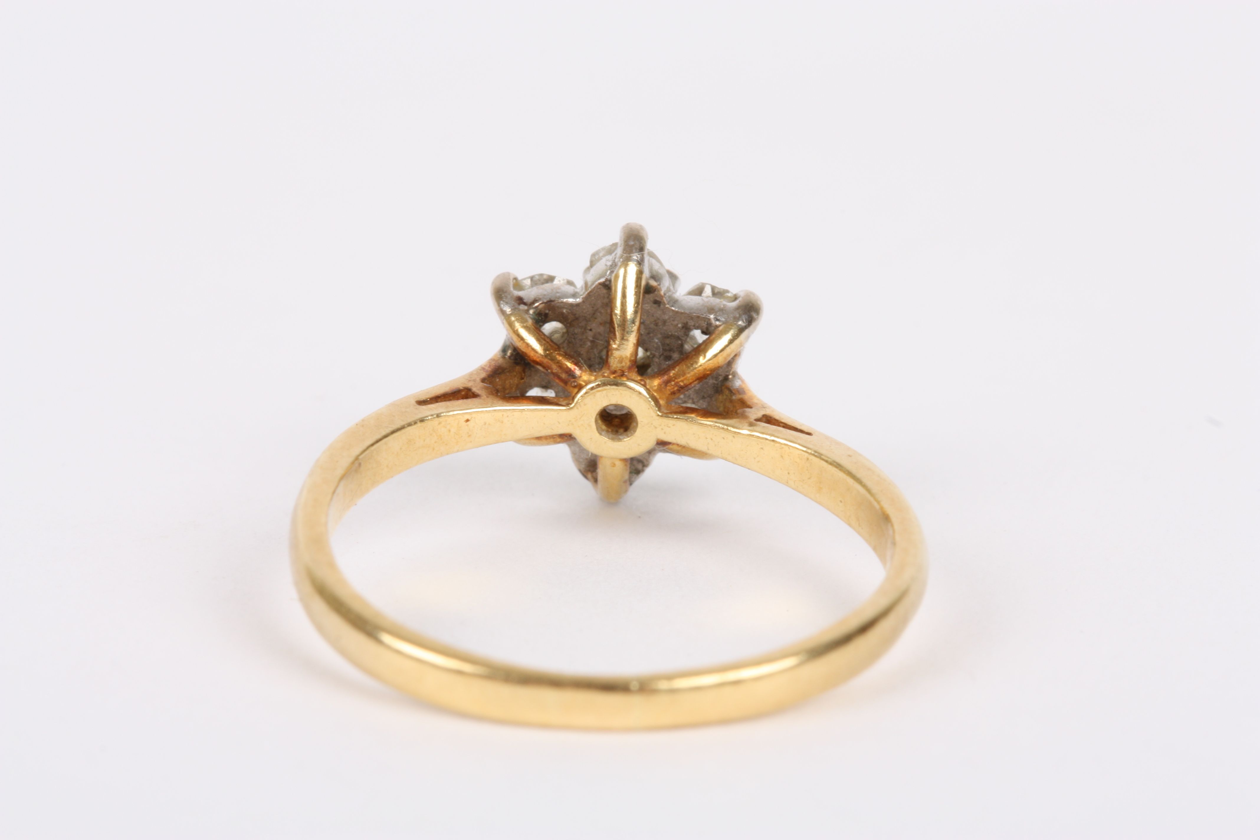 An 18ct gold and diamond ring
the diamond set in flower head, the central diamond set with six - Image 2 of 2