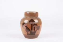 A Moorcroft Mushroom Brown ginger jar and coverthe body and lid decorated with mushrooms on a