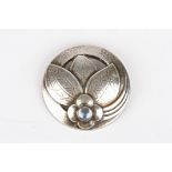 A Georg Jensen silver and moonstone circular brooch
formed as a flower head and leaves, of domed