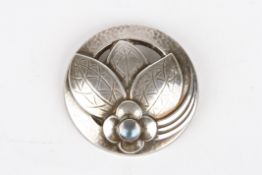 A Georg Jensen silver and moonstone circular broochformed as a flower head and leaves, of domed