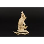 A Japanese ivory figure of a fish and a man 
the large carved fish having jumped from the coral
