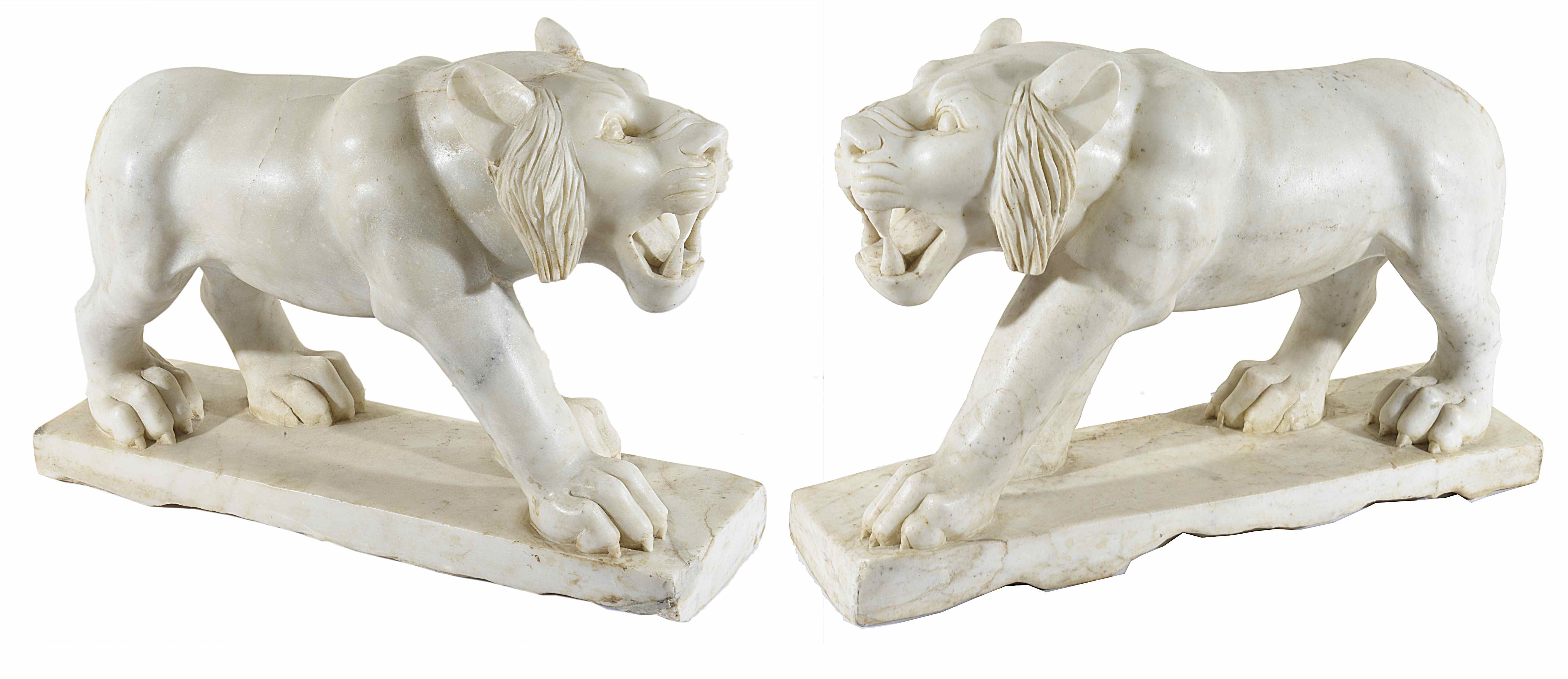 A pair of decorative white marble lions
realistically modelled, in standing poses, on marble bases