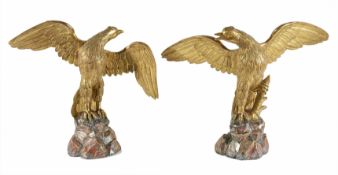 A pair of gilt wood birdsnaturalistically carved in flight, on carved wooden basesDimensions: