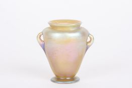 A Louis Comfort Tiffany Favrile iridescent glass vaseof urn shaped form with small loop handles,