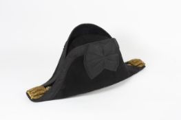 A felt bicorn hatcontained within a fitted tin case with gilt lettering reading F. Cartwright R.