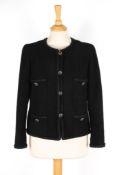 A Chanel black boucle jacket with four pockets to front, with braid trim, single breasted, four