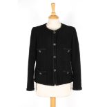 A Chanel black boucle jacket 
with four pockets to front, with braid trim, single breasted, four