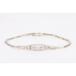 An Art Deco 18ct gold and diamond bracelet
set with central diamond weighing approximately 0.