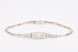 An Art Deco 18ct gold and diamond braceletset with central diamond weighing approximately 0.