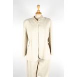 A Valentino trouser suit.
light beige suit with open fronted jacket trimmed with beading to collar