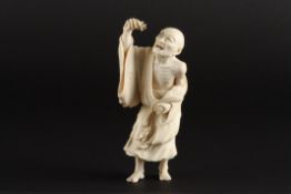 A Japanese ivory okimono figure of a man with a lobsterprobably early 20th centurythe standing