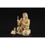 A Japanese ivory okimono figure of a seated man with rats
late 19th/early 20th century the seated