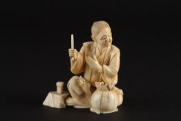 A Japanese ivory okimono figure of a seated man with ratslate 19th/early 20th century the seated