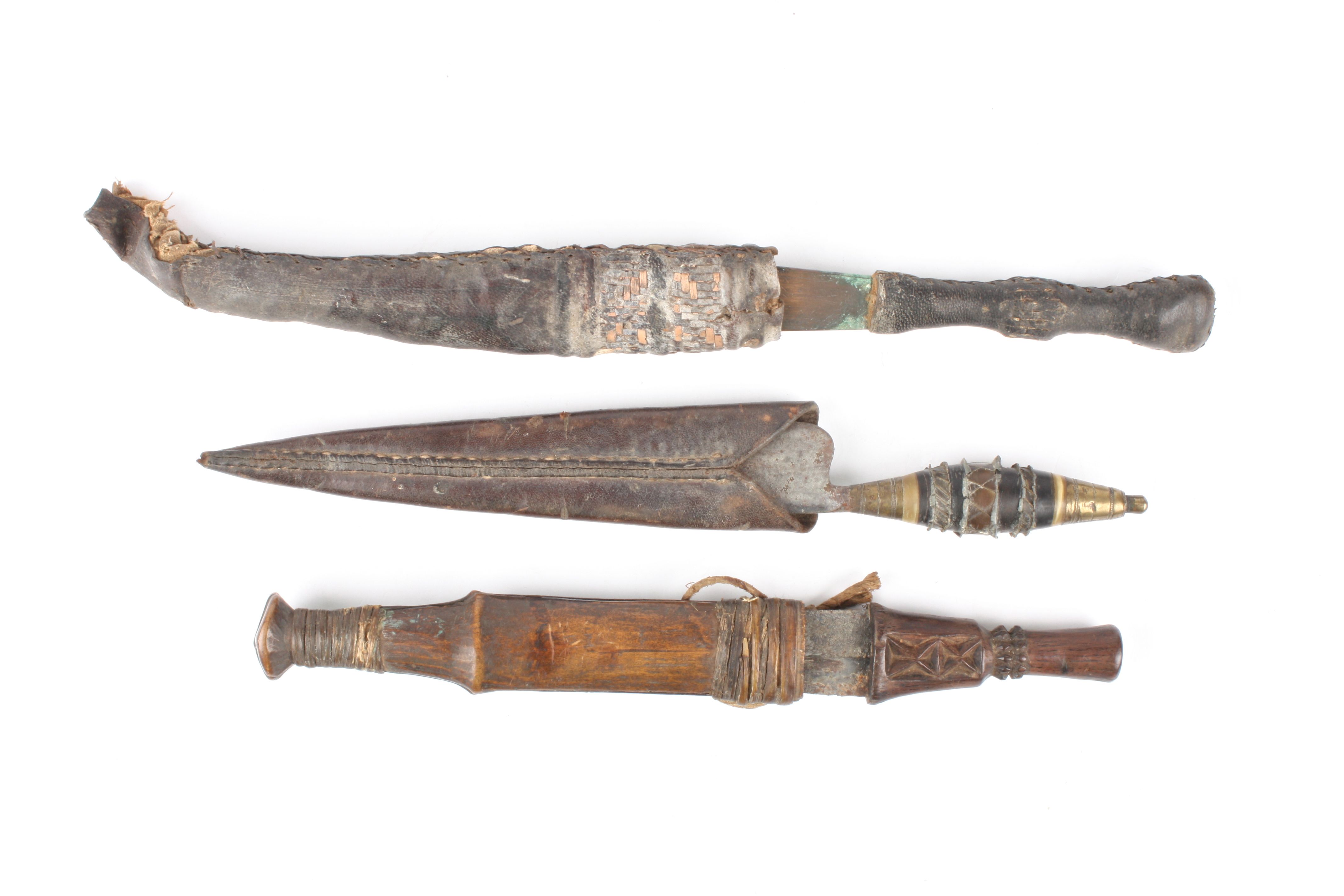 A group of three 19th century tribal daggers
two with leather scabbards, one with wooden - Image 2 of 2