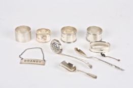 A collection of assorted silverwareincluding napkin rings, a decanter label, caddy spoon and