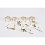 A collection of assorted silverware
including napkin rings, a decanter label, caddy spoon and