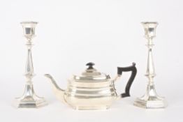 A silver teapothallmarked London 1905 of squat form with ebonised handle and knop, together with