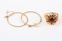 A 9ct gold and garnet cluster ringof floral form, with large central garnet surrounded by leaves