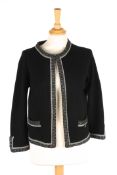 A black Chanel cashmere jacket with grey piping and two pockets to front with small silver