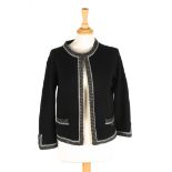 A black Chanel cashmere jacket with grey piping and two pockets to front with small silver