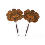 A pair of Regency lacquered chinoiserie fans
of paddle form, the shaped wooden fans with central