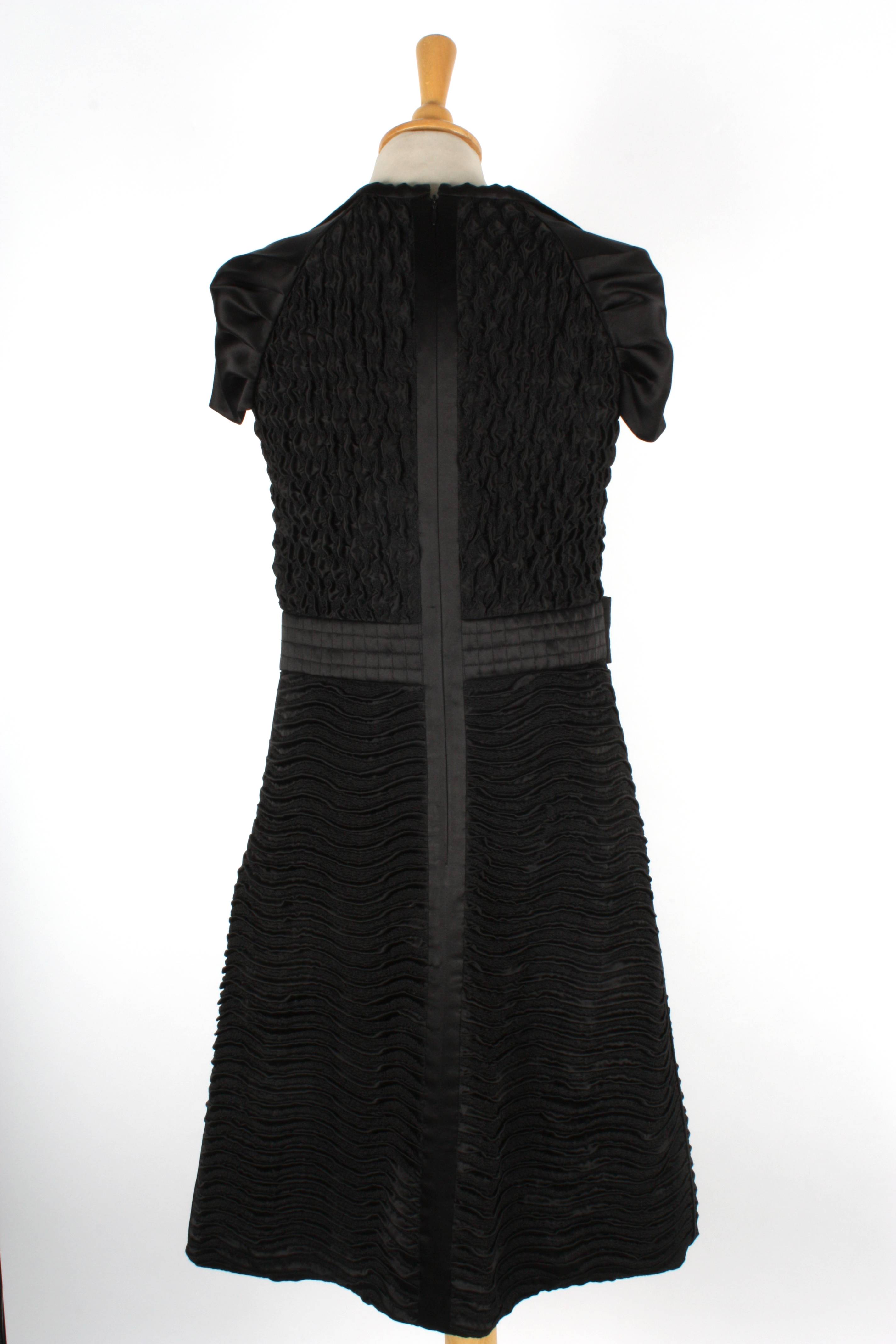 A black silk Prada evening dress
with ruche top, bow to side, decorative cap sleeves and ruche skirt - Image 2 of 2