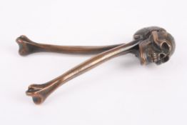 A pair of late 19th century novelty nut crackers in the form of a skull and bonesRd 740410, the