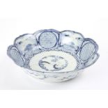 A 19th century Chinese blue and white bowl
of lobed petal form, painted with a central garden scene,