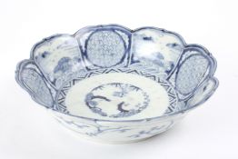 A 19th century Chinese blue and white bowlof lobed petal form, painted with a central garden scene,
