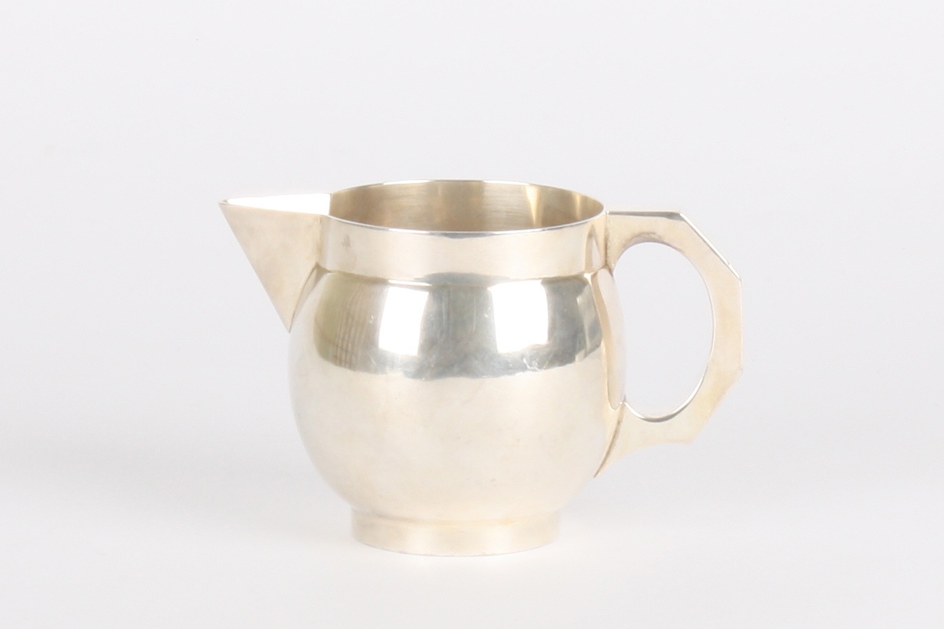 A George V globular silver cream jug
hallmarked Birmingham 1912, of plain form with sparrow beak