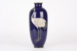 An early 20th century Japanese cloisonné vasedecorated with a crane in relief upon a rich blue