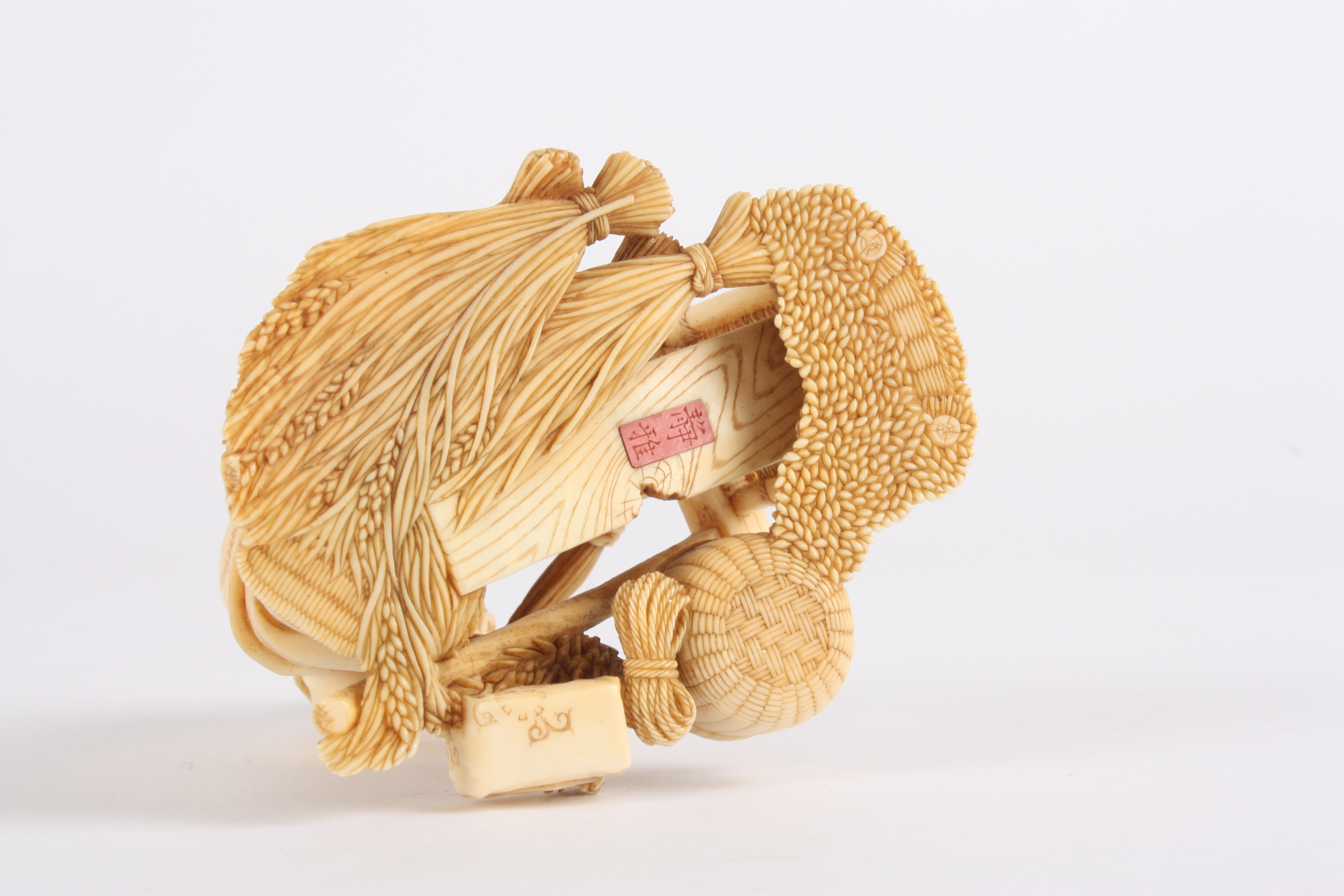 A Japanese finely carved ivory figure of a man
stood threshing corn using a foot operated machine, - Image 5 of 5