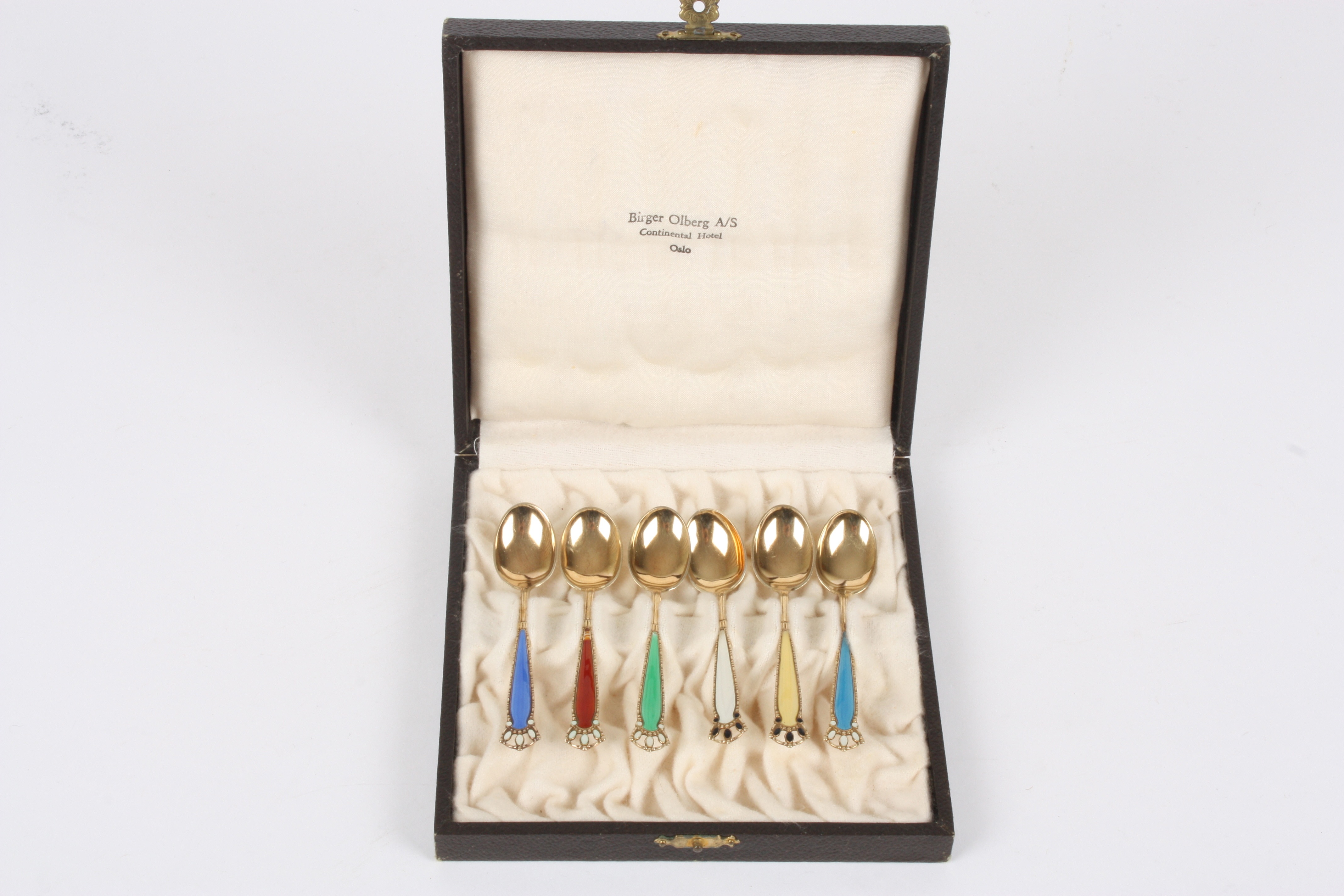 A set of six Norwegian silver gilt and enamel spoons
in a fitted case, retailed by Birger Olberg,