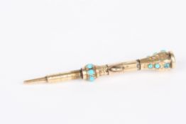 A gold coloured metal propelling pencilwith mounted turquoise stones and amethyst, suspension