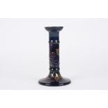 A Moorcroft Blue Finches candlestick
decorated with a finch, leaves and berries on a blue ground,