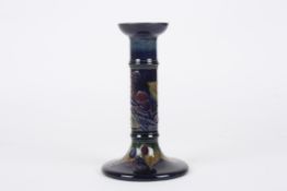 A Moorcroft Blue Finches candlestickdecorated with a finch, leaves and berries on a blue ground,