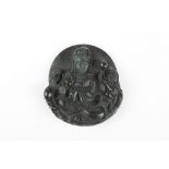 A Chinese Ming style carved dark spinach jade pendant
finely carved as a guan yin surrounded by