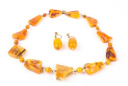 An early 20th century rough amber coloured necklacetogether with a pair of amber coloured bead