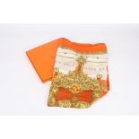 Two Hermès printed silk scarves in original boxes, 
one predominantly orange, cream, gold and